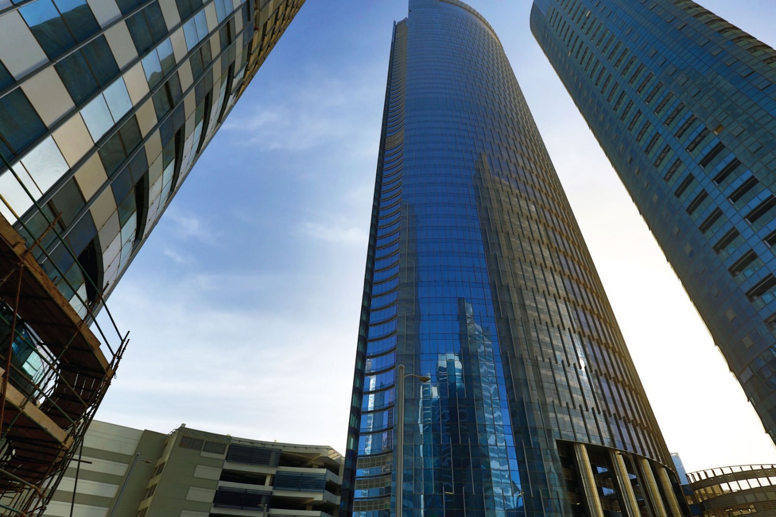 Modern glass multi level podium structure and grand entrance facade at Addax Office Tower in Al Reem Island Abu Dhabi.