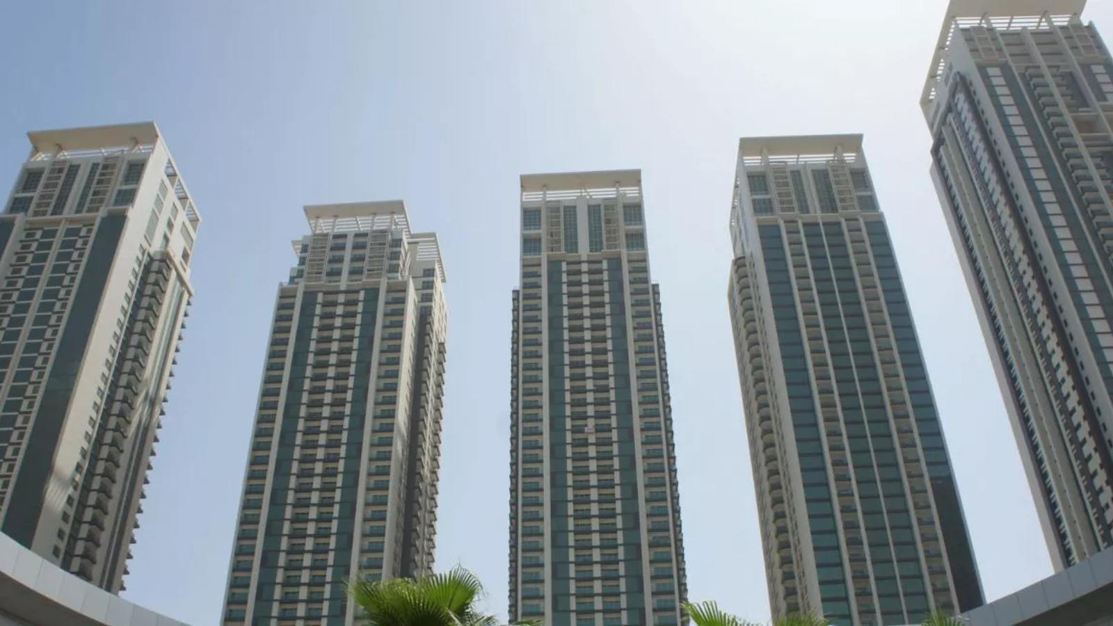 Waterfront exterior of Marina Heights in Marina Square, Al Reem Island, Abu Dhabi, featuring luxury residential towers and urban skyline views.